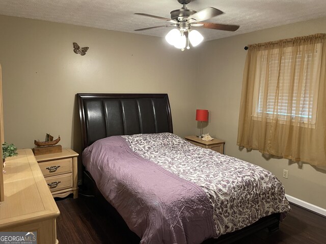 501 Lakeshore Dr, Monticello, GA 31064 - bedroom with dark wood-style floors, a textured ceiling, baseboards, and ceiling fan