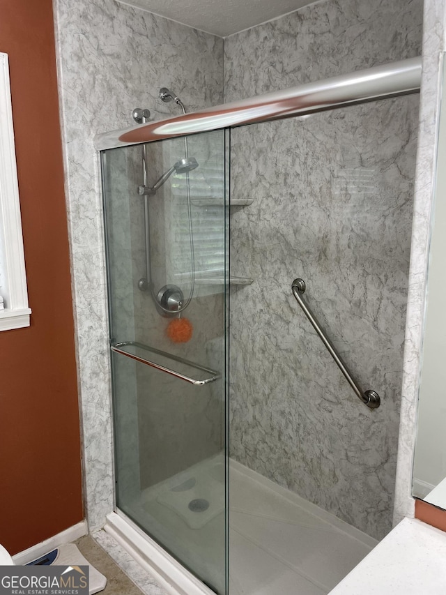 501 Lakeshore Dr, Monticello, GA 31064 - bathroom featuring a shower stall and baseboards