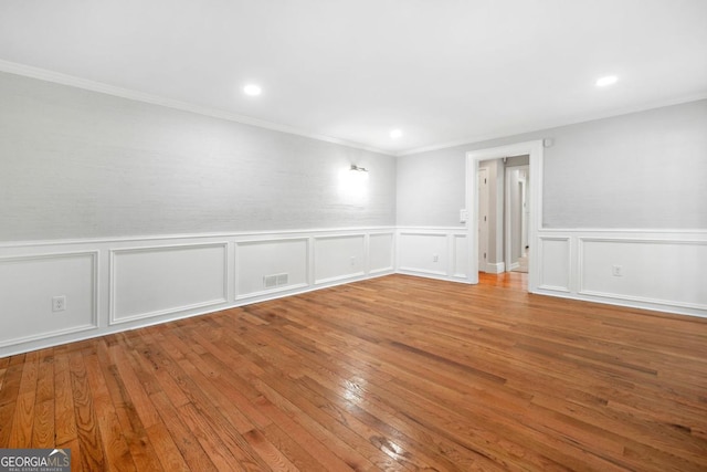 4197 Chadds Xing, Marietta, GA 30062 - spare room featuring wood-type flooring, a wainscoted wall, crown molding, recessed lighting, and a decorative wall