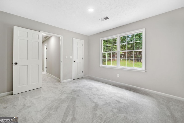 4197 Chadds Xing, Marietta, GA 30062 - unfurnished bedroom featuring carpet, baseboards, a textured ceiling, and recessed lighting