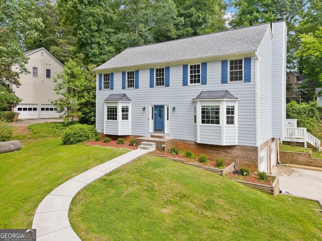 4197 Chadds Xing, Marietta, GA 30062 - colonial-style house featuring a chimney, an attached garage, a front lawn, driveway, and roof with shingles