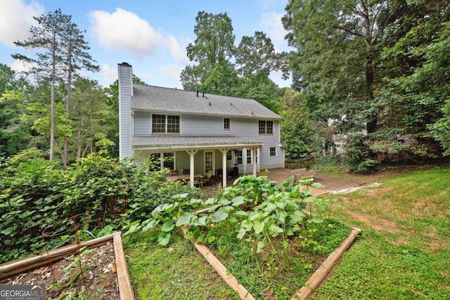4197 Chadds Xing, Marietta, GA 30062 - rear view of house featuring a garden, a chimney, and a patio