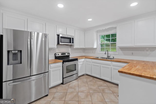 4197 Chadds Xing, Marietta, GA 30062 - kitchen featuring appliances with stainless steel finishes, wood counters, a sink, light tile patterned flooring, and recessed lighting