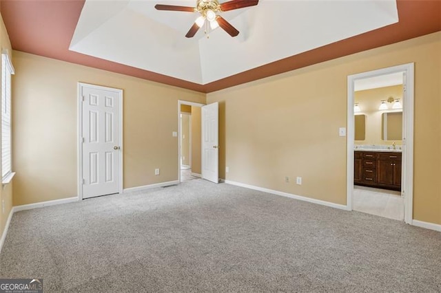 12290 Greenmont Walk, Alpharetta, GA 30009 - unfurnished bedroom featuring a raised ceiling, light carpet, baseboards, and connected bathroom