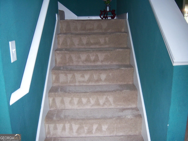225 Long Creek Dr, Covington, GA 30016 - staircase featuring a chandelier