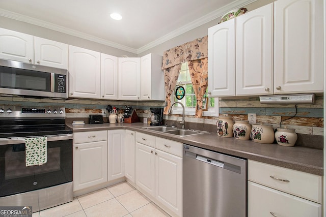 325 Leonard Rd, Lagrange, GA 30241 - kitchen featuring appliances with stainless steel finishes, a sink, tasteful backsplash, ornamental molding, and white cabinetry