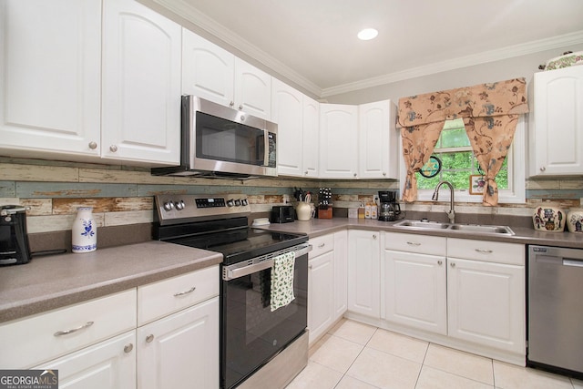 325 Leonard Rd, Lagrange, GA 30241 - kitchen featuring appliances with stainless steel finishes, a sink, crown molding, decorative backsplash, and light tile patterned flooring
