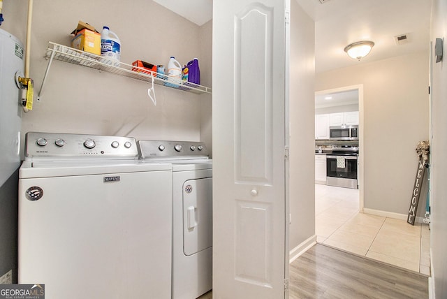 325 Leonard Rd, Lagrange, GA 30241 - washroom featuring washing machine and dryer, baseboards, and light wood finished floors