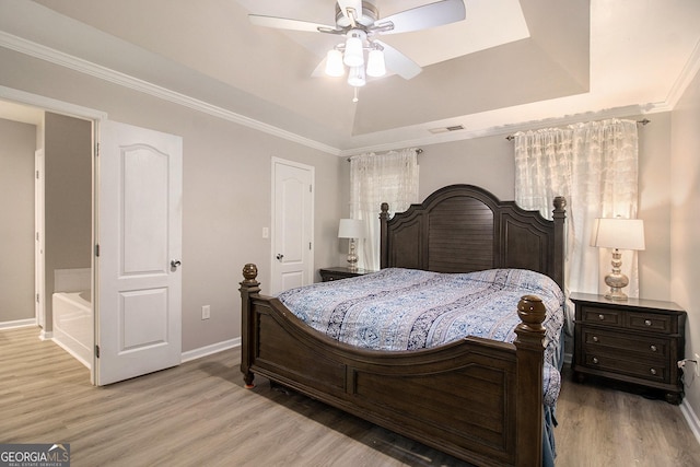 325 Leonard Rd, Lagrange, GA 30241 - bedroom with light wood-style floors, baseboards, a tray ceiling, crown molding, and a ceiling fan