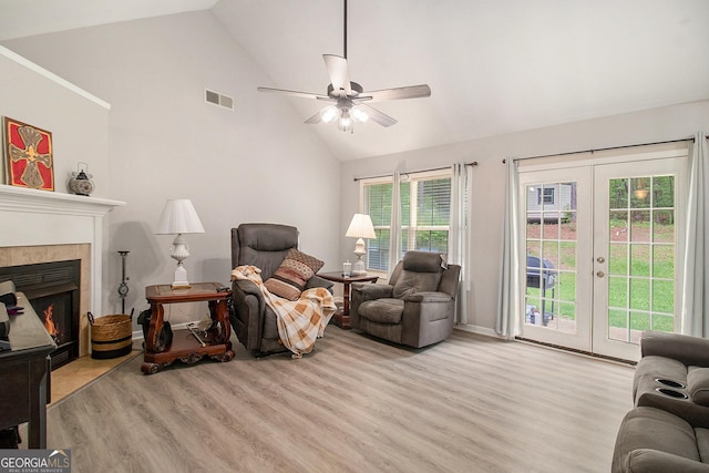 325 Leonard Rd, Lagrange, GA 30241 - living room featuring light wood-style flooring, a ceiling fan, french doors, high vaulted ceiling, and a tiled fireplace