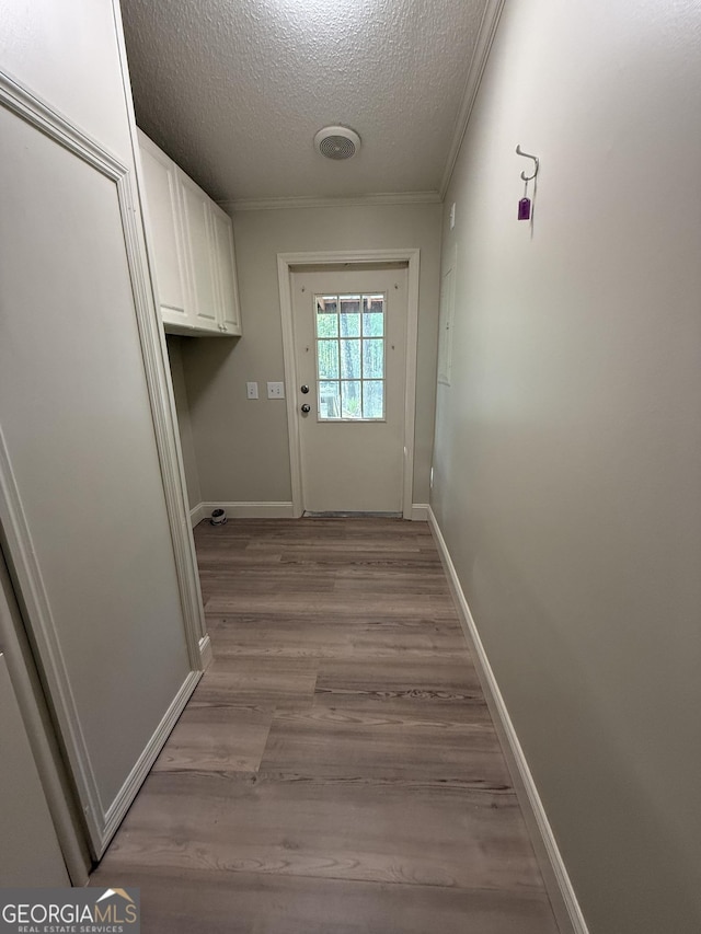 179 Creek Ridge Rd, Claxton, GA 30417 - entryway with a textured ceiling, light wood-style flooring, baseboards, and ornamental molding