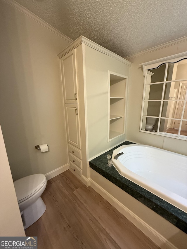 179 Creek Ridge Rd, Claxton, GA 30417 - full bathroom with a textured ceiling, crown molding, wood finished floors, toilet, and a bath