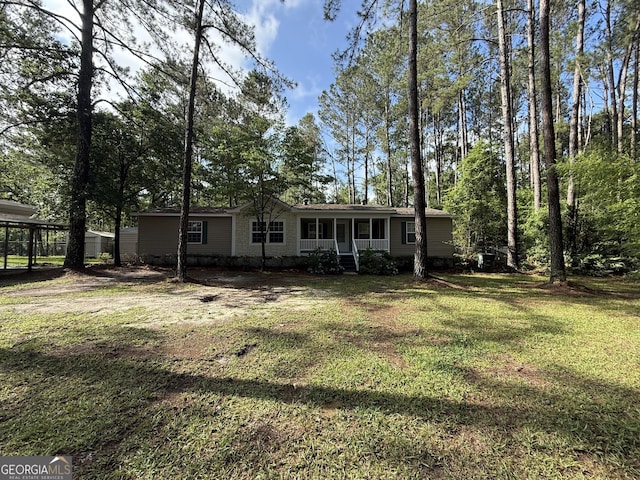 179 Creek Ridge Rd, Claxton, GA 30417 - back of house with covered porch, a lawn, and a carport
