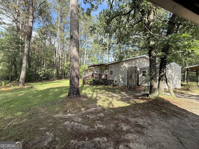 179 Creek Ridge Rd, Claxton, GA 30417 - view of grassy yard with a deck and an outbuilding