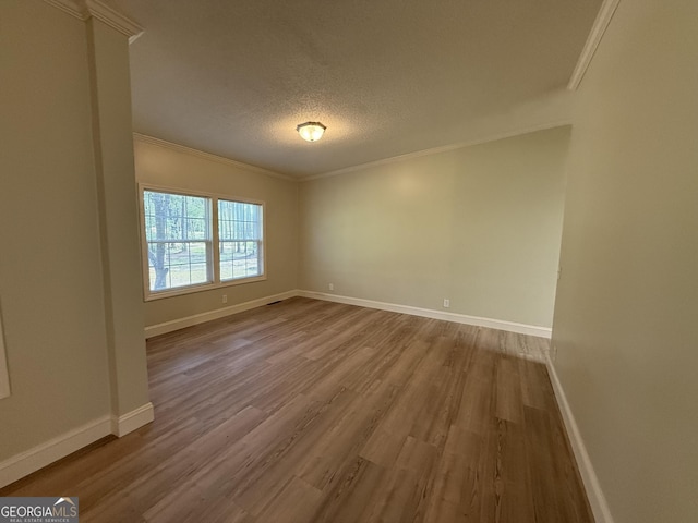 179 Creek Ridge Rd, Claxton, GA 30417 - unfurnished room with wood finished floors, crown molding, baseboards, and a textured ceiling