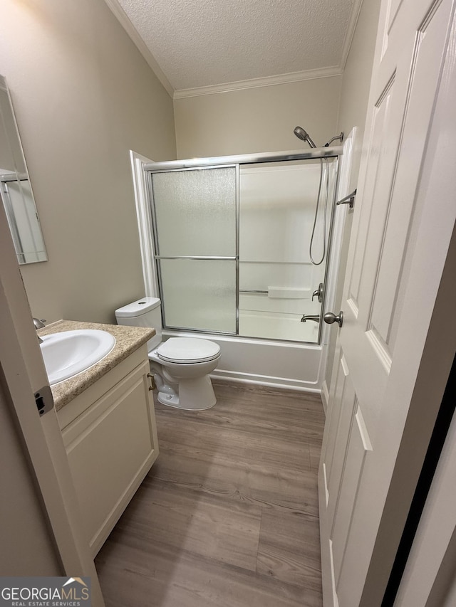 179 Creek Ridge Rd, Claxton, GA 30417 - bathroom with vanity, ornamental molding, toilet, wood finished floors, and a textured ceiling