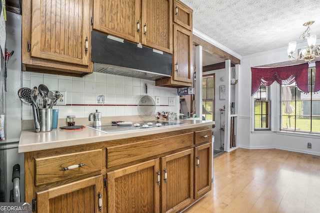 2969 White Rd NE, Conyers, GA 30012 - kitchen with extractor fan, backsplash, brown cabinetry, ornamental molding, and a textured ceiling