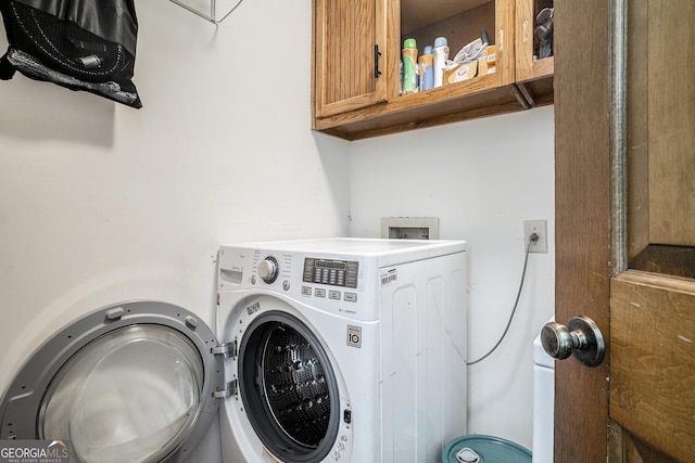 2969 White Rd NE, Conyers, GA 30012 - laundry room with washing machine and clothes dryer and cabinet space