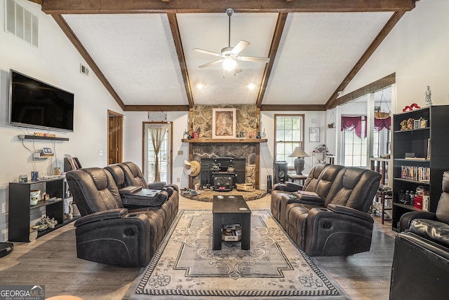 2969 White Rd NE, Conyers, GA 30012 - living room featuring a ceiling fan, wood finished floors, and a stone fireplace