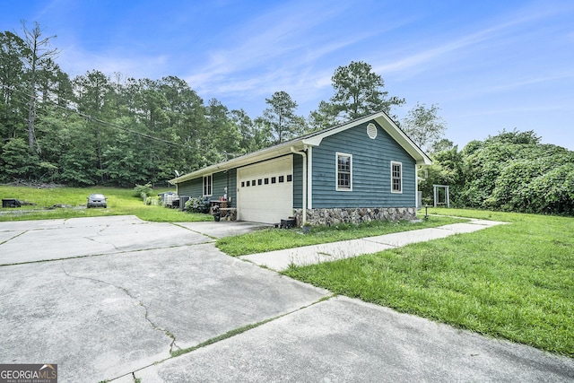 2969 White Rd NE, Conyers, GA 30012 - view of side of property with a lawn, concrete driveway, and an attached garage