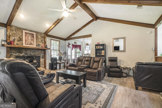 2969 White Rd NE, Conyers, GA 30012 - living area featuring light wood-style flooring, ceiling fan, and a stone fireplace