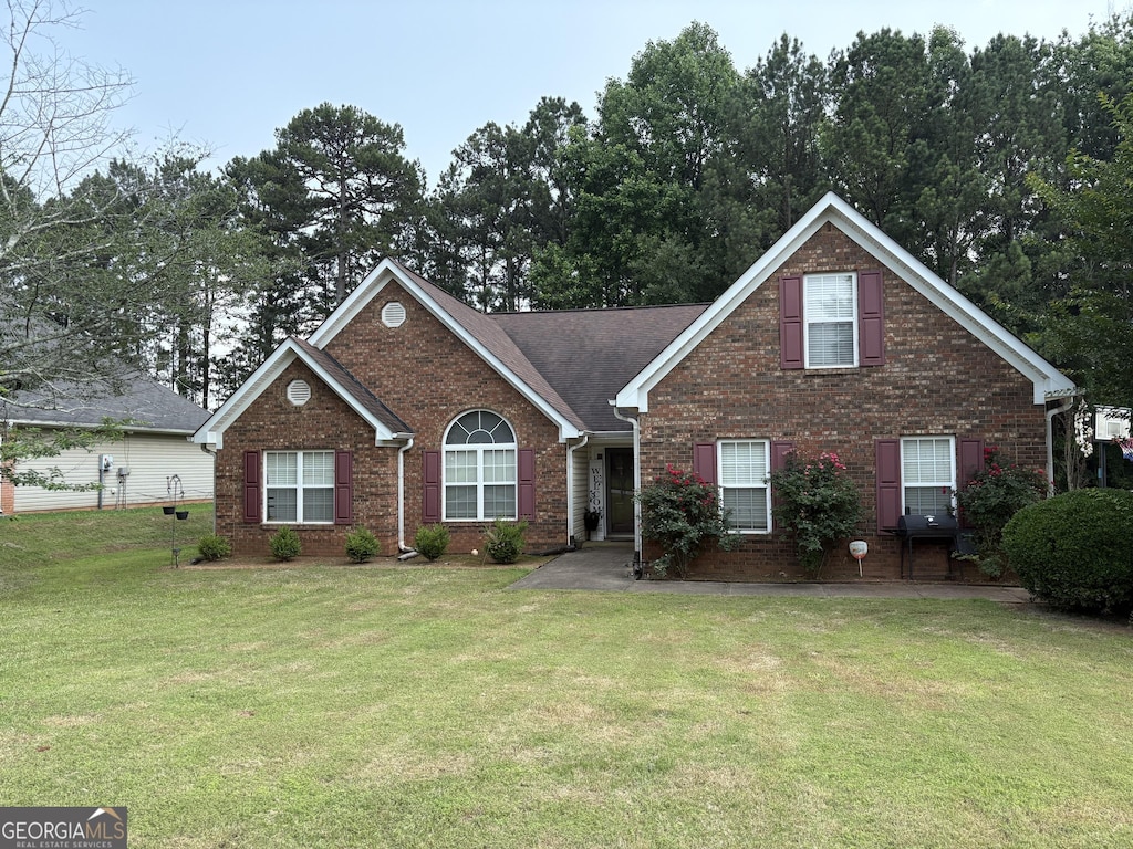 85 Bermuda Run Dr, Covington, GA 30016 - view of front facade with brick siding and a front yard
