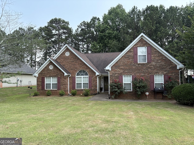85 Bermuda Run Dr, Covington, GA 30016 - view of front facade with brick siding and a front yard