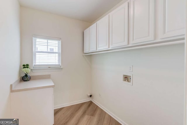 7653 Legacy Rd, Flowery Branch, GA 30542 - laundry area with cabinet space, washer hookup, and light wood-type flooring