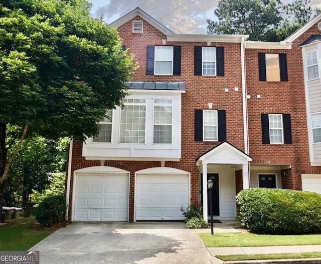 5996 Eagle Tiff Ln, Sugar Hill, GA 30518 - townhome / multi-family property with driveway, an attached garage, and brick siding