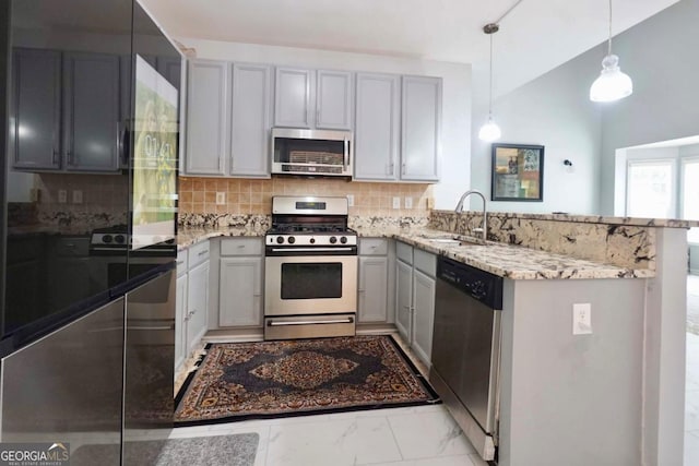5996 Eagle Tiff Ln, Sugar Hill, GA 30518 - kitchen featuring appliances with stainless steel finishes, gray cabinets, light stone countertops, a peninsula, and tasteful backsplash