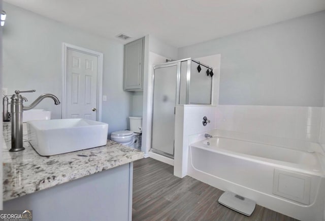 5996 Eagle Tiff Ln, Sugar Hill, GA 30518 - bathroom with vanity, a bath, a stall shower, and wood finished floors