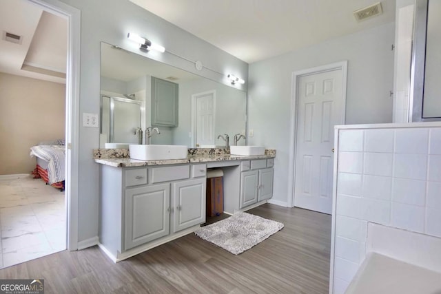5996 Eagle Tiff Ln, Sugar Hill, GA 30518 - ensuite bathroom featuring a stall shower, vanity, and wood finished floors
