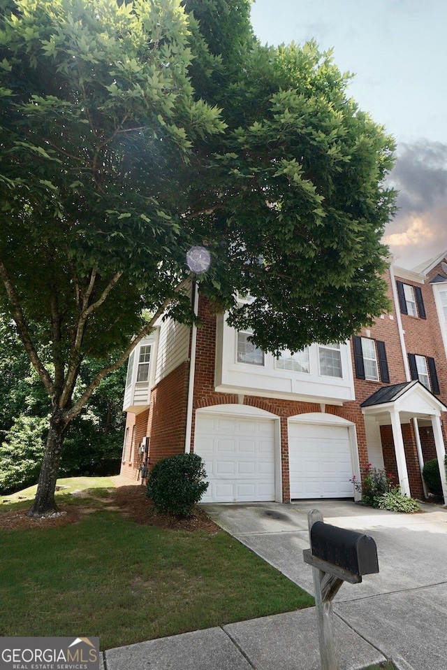 5996 Eagle Tiff Ln, Sugar Hill, GA 30518 - view of front of home featuring brick siding, concrete driveway, and a garage