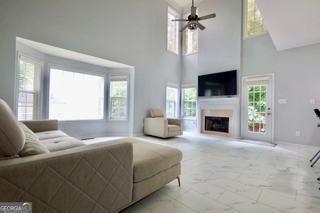 5996 Eagle Tiff Ln, Sugar Hill, GA 30518 - living room with marble look tiles, plenty of natural light, ceiling fan, and a high ceiling