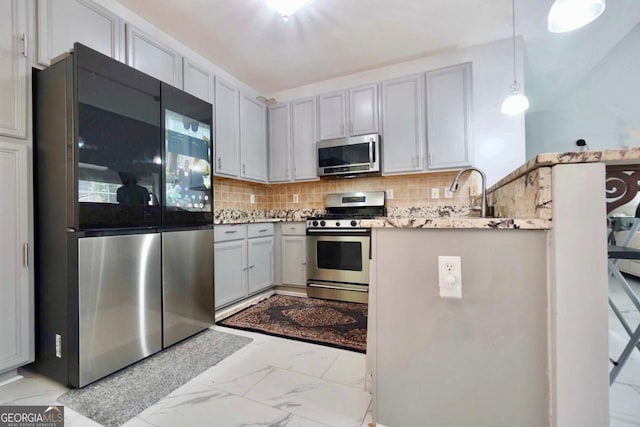 5996 Eagle Tiff Ln, Sugar Hill, GA 30518 - kitchen featuring stainless steel appliances, light marble finish floors, tasteful backsplash, a peninsula, and decorative light fixtures