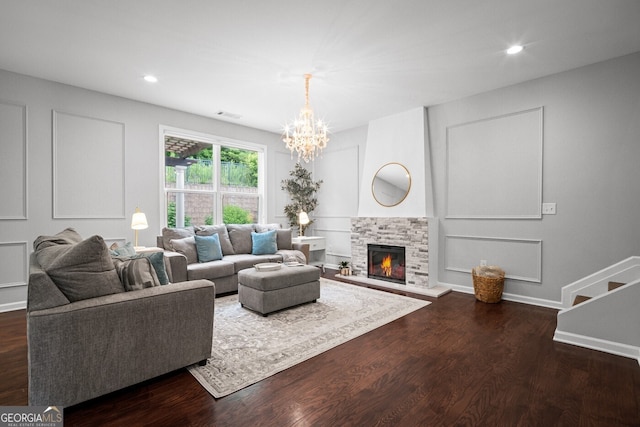 149 Archie Way, Woodstock, GA 30188 - living room featuring dark wood-type flooring, a chandelier, a fireplace, recessed lighting, and baseboards