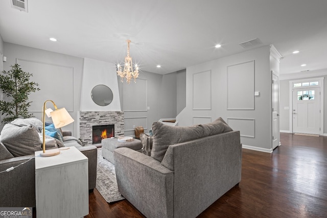 149 Archie Way, Woodstock, GA 30188 - living room with dark wood finished floors, a chandelier, recessed lighting, baseboards, and a fireplace