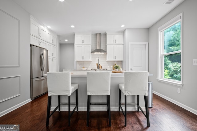 149 Archie Way, Woodstock, GA 30188 - kitchen featuring freestanding refrigerator, wall chimney range hood, plenty of natural light, tasteful backsplash, and recessed lighting