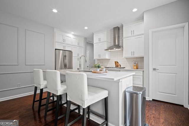149 Archie Way, Woodstock, GA 30188 - kitchen with wall chimney range hood, stainless steel appliances, a sink, backsplash, and light countertops
