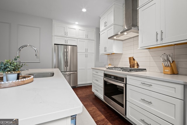 149 Archie Way, Woodstock, GA 30188 - kitchen featuring appliances with stainless steel finishes, wall chimney exhaust hood, a sink, dark wood-style flooring, and recessed lighting