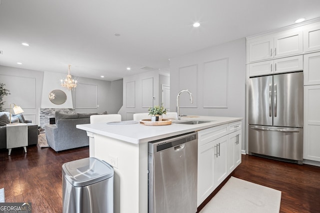 149 Archie Way, Woodstock, GA 30188 - kitchen featuring stainless steel appliances, a sink, open floor plan, white cabinets, and recessed lighting