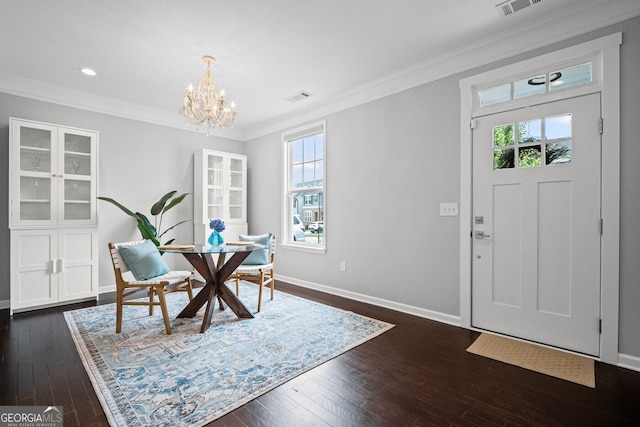 149 Archie Way, Woodstock, GA 30188 - dining room with a chandelier, healthy amount of natural light, dark wood-style floors, ornamental molding, and recessed lighting