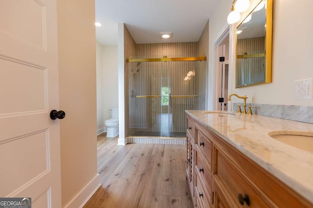 408 Mock St, Sylvania, GA 30467 - full bath with toilet, double vanity, a stall shower, and wood finished floors