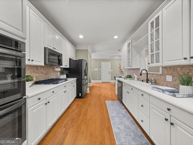 121 Fulton Way SE, Atlanta, GA 30312 - kitchen with stainless steel appliances, baseboards, white cabinetry, backsplash, and light countertops