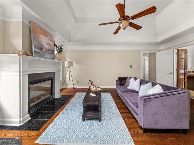 121 Fulton Way SE, Atlanta, GA 30312 - living room featuring a raised ceiling, a fireplace, ceiling fan, baseboards, and crown molding