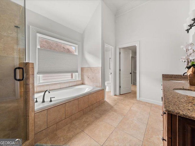 121 Fulton Way SE, Atlanta, GA 30312 - bathroom featuring a bath, double vanity, a shower stall, crown molding, and tile patterned floors