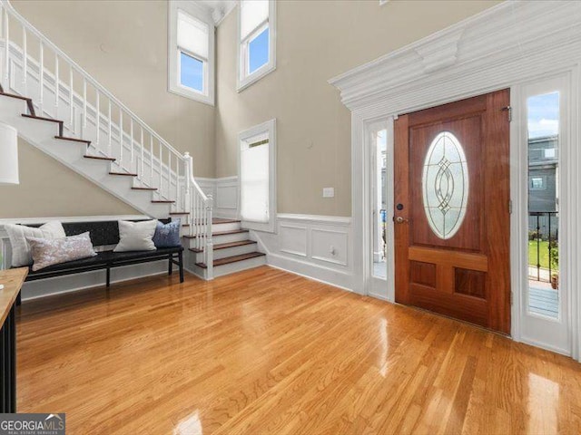 121 Fulton Way SE, Atlanta, GA 30312 - entrance foyer featuring stairs, light wood finished floors, wainscoting, a decorative wall, and a high ceiling