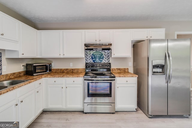 236 Fairview Dr, Dallas, GA 30157 - kitchen featuring stainless steel appliances, under cabinet range hood, white cabinets, and light wood-style floors