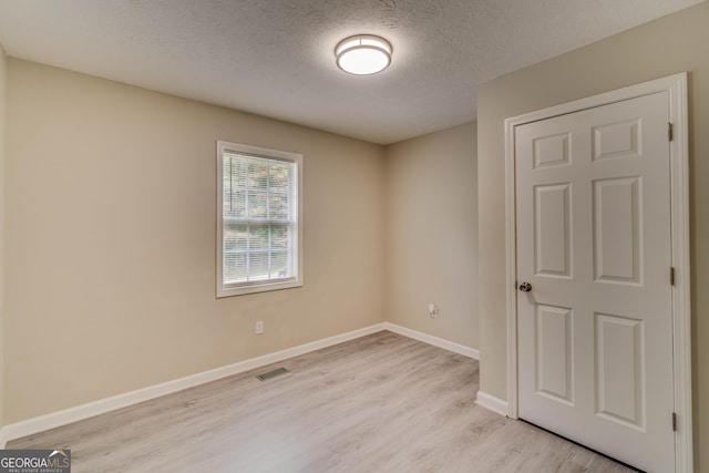 236 Fairview Dr, Dallas, GA 30157 - spare room featuring light wood-style flooring, baseboards, and a textured ceiling