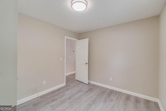 236 Fairview Dr, Dallas, GA 30157 - spare room featuring light wood-style flooring, baseboards, and a textured ceiling